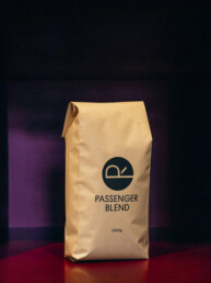 PASSENGER BLEND coffee bag—our house espresso blend featuring flavors of dark chocolate, almond, molasses, and blueberry.